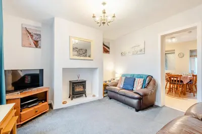 a living room with a leather chair and a television at 2 Bed in Haverigg oc-s33747 in Haverigg