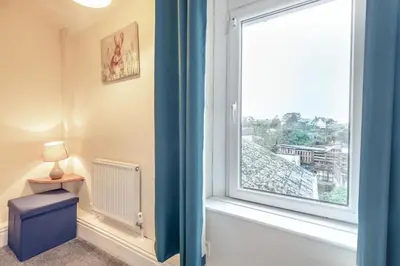 a room with a large window and a blue curtain at 2 Bed in Haverigg oc-s33747 in Haverigg