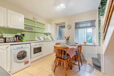 a kitchen with a table and a washing machine at 2 Bed in Haverigg oc-s33747 in Haverigg