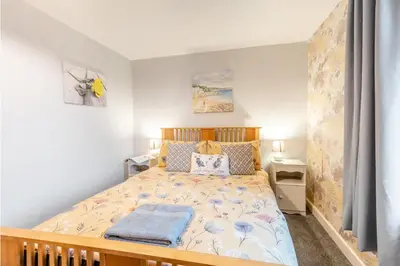 a bedroom with a bed and two night stands at 2 Bed in Haverigg oc-s33747 in Haverigg