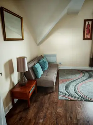 a living room with a couch and a table at MARLEY MANSIONS APARTMENT Clarendon FT3 in Wallasey