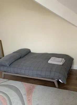 a bed sitting against a wall in a room at MARLEY MANSIONS APARTMENT Clarendon FT3 in Wallasey