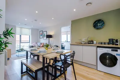 a kitchen and dining room with a table and chairs at High End 2BR 2BA Parking City Access in Liverpool