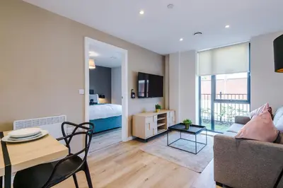 a living room with a couch and a table and a bed at High End 2BR 2BA Parking City Access in Liverpool