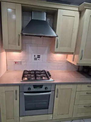 a kitchen with a stove and a hood at The Nightingale in Lower Darwen