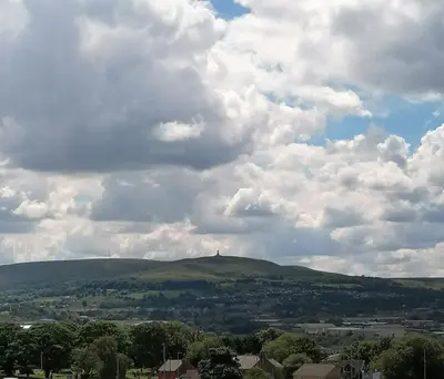 a view of a hill under a cloudy sky at The Nightingale in Lower Darwen