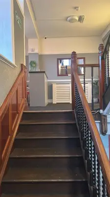 a set of stairs in a building with a stair case at Sheridans hotel in Wallasey
