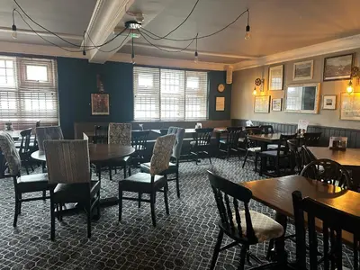a dining room with tables and chairs in a restaurant at Sheridans hotel in Wallasey