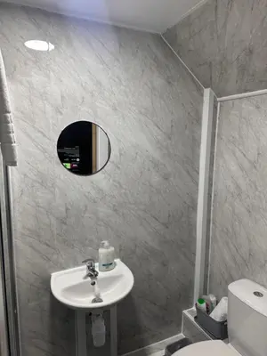 a bathroom with a sink and a mirror at Sheridans hotel in Wallasey