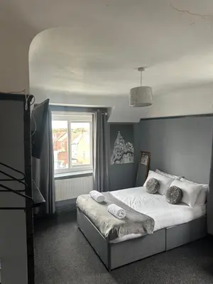 a bedroom with a bed and a window at Sheridans hotel in Wallasey