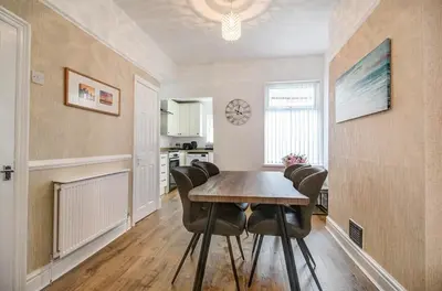 a dining room with a table and chairs at Beach Meets City - Two Bed Stay Near to Liverpool in Wallasey