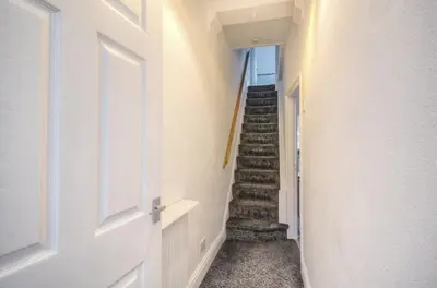 a hallway with a stairway with a stair case at Beach Meets City - Two Bed Stay Near to Liverpool in Wallasey