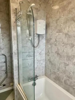 a bathroom with a shower and a bath tub at Southport-Birkdale Luxury Haven in Southport