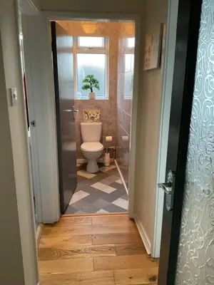 a bathroom with a toilet and a window at Southport-Birkdale Luxury Haven in Southport