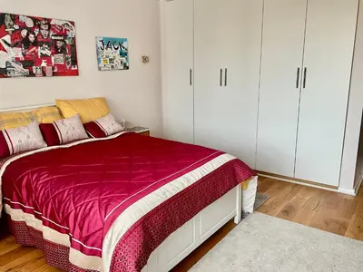 a bedroom with a bed and white cabinets at Southport-Birkdale Luxury Haven in Southport