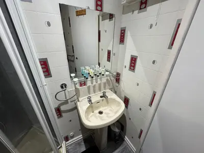 a bathroom with a sink and a mirror at Waverley Beach Hotel in Blackpool