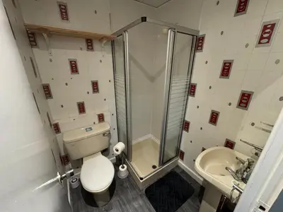 a bathroom with a shower and a toilet and a sink at Waverley Beach Hotel in Blackpool