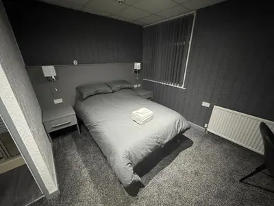 a small bedroom with a bed and two night stands at Waverley Beach Hotel in Blackpool