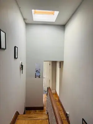 a hallway with a staircase with a skylight at Wallasey Nest in Wallasey