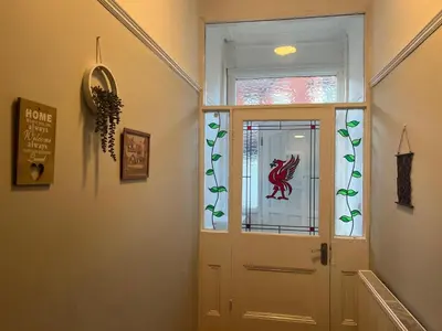 a hallway with a door with a red horse on it at Wallasey Nest in Wallasey