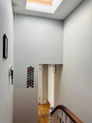 a hallway with white walls and a skylight at Wallasey Nest in Wallasey