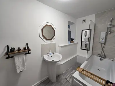 a white bathroom with a sink and a mirror at Room 1 Shared House 3 min from Stadium in Liverpool