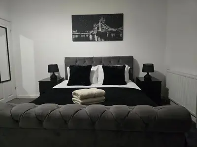 a bedroom with a large bed with a bridge at Room 1 Shared House 3 min from Stadium in Liverpool