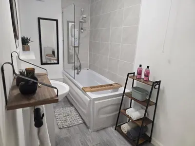 a bathroom with a tub and a toilet and a sink at Room 1 Shared House 3 min from Stadium in Liverpool