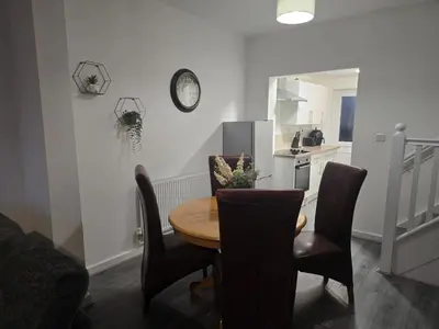 a kitchen and dining room with a table and chairs at Room 2 Shared House 3 min from Stadium in Liverpool
