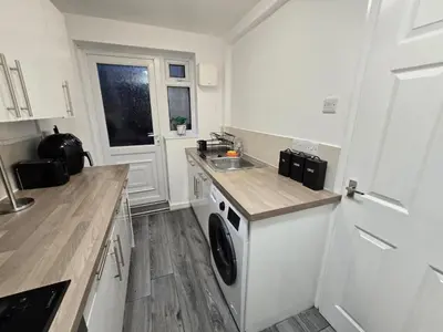 a kitchen with a washing machine and a sink at Room 2 Shared House 3 min from Stadium in Liverpool