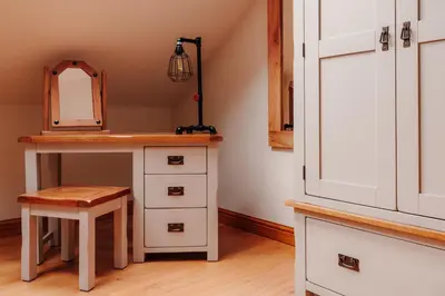 a dressing table with a mirror and a stool at Ellenboro House, Cosy Sleeps 2, Near Cartmel in Grange Over Sands