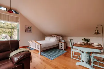 a living room with a bed and a table at Ellenboro House, Cosy Sleeps 2, Near Cartmel in Grange Over Sands