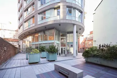 a large building with a bench in front of it at Host & Stay - Hatton Garden Apartments in Liverpool