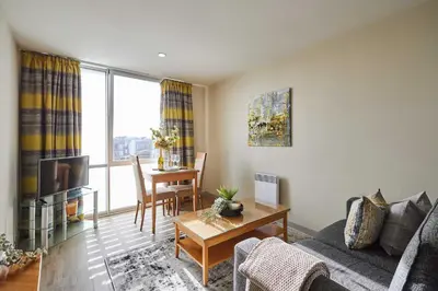 a living room with a couch and a table at Host & Stay - Hatton Garden Apartments in Liverpool