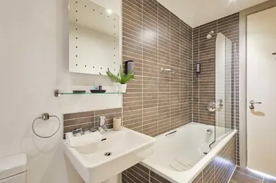 a bathroom with a sink and a bath tub at Host & Stay - Hatton Garden Apartments in Liverpool