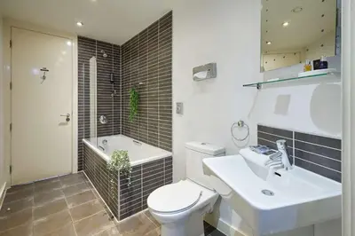 a bathroom with a toilet and a sink and a tub at Host & Stay - Hatton Garden Apartments in Liverpool