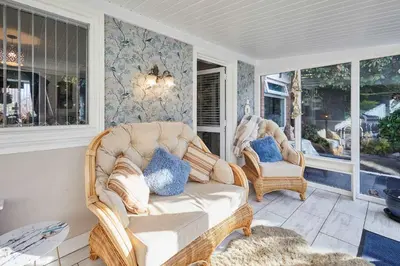 a porch with a wicker couch and two chairs at Host & Stay - The Cheeky Squirrel in New Brighton
