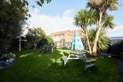 an umbrella and a table in a yard at Host & Stay - The Cheeky Squirrel in New Brighton