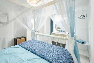 a bedroom with a bed with a canopy and a window at Host & Stay - The Cheeky Squirrel in New Brighton