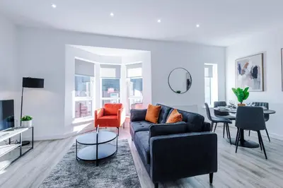 a living room with a couch and a table at Modern 2BR Flat with Parking, Fully Equipped, Sleeps 4 in Liverpool