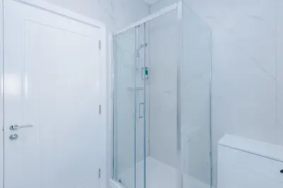 a shower with a glass door in a bathroom at Modern 2BR Flat with Parking, Fully Equipped, Sleeps 4 in Liverpool