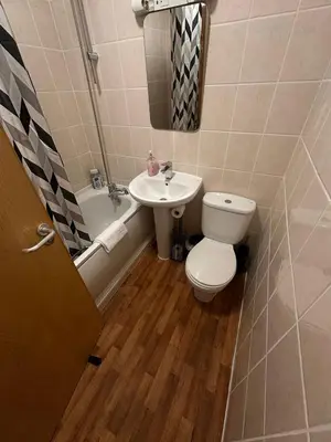 a bathroom with a toilet and a sink at Spacious City Centre 2-Bedroom Apartment by StaySavvy Accommodation in Liverpool