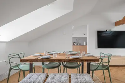 a dining room with a wooden table and chairs at Ford Park House Penthouse Escape in Ulverston