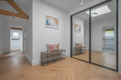 a glass door in a room with a wooden floor at Ford Park House Penthouse Escape in Ulverston