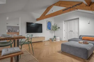 a living room with a couch and a table at Ford Park House Penthouse Escape in Ulverston