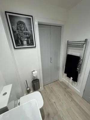a bathroom with a white toilet and a sink at Cosy Modern 2 Beds Chorley Center in Chorley