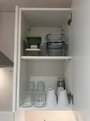 a white cabinet with some glass items in it at Cosy Modern 2 Beds Chorley Center in Chorley
