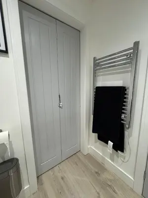 a bathroom with a door with a towel on it at Cosy Modern 2 Beds Chorley Center in Chorley