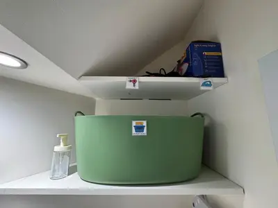 a shelf with a green container on top of it at Cosy Modern 2 Beds Chorley Center in Chorley
