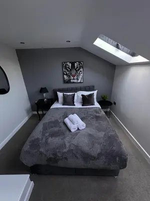 a bedroom with a large bed with two towels on it at City Centre Duplex Apartment Liverpool in Liverpool
